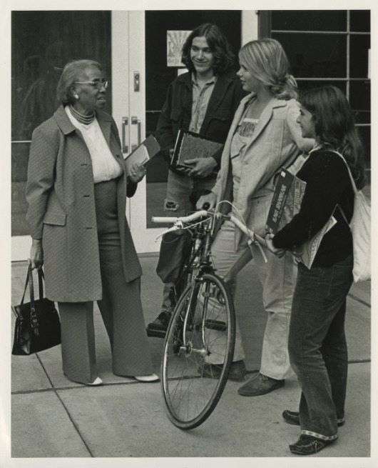 Black and white photograph of Septima P. Clark talking with University of California, Santa Cruz students outdoors.