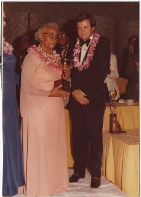 Color photograph of Septima P. Clark holding trophy next to gentleman at National Education Association Award.